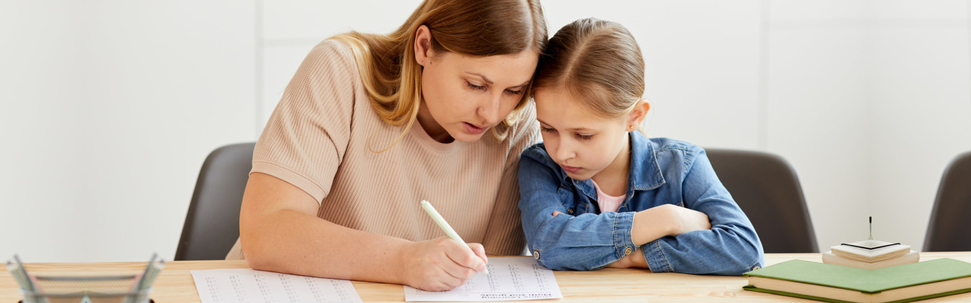 teacher teaching the child how to write